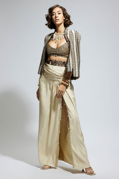 Embellished & Textured Cape Jacket Paired with Metallic Scallop Bustier and Ivory  High Slit Skirt