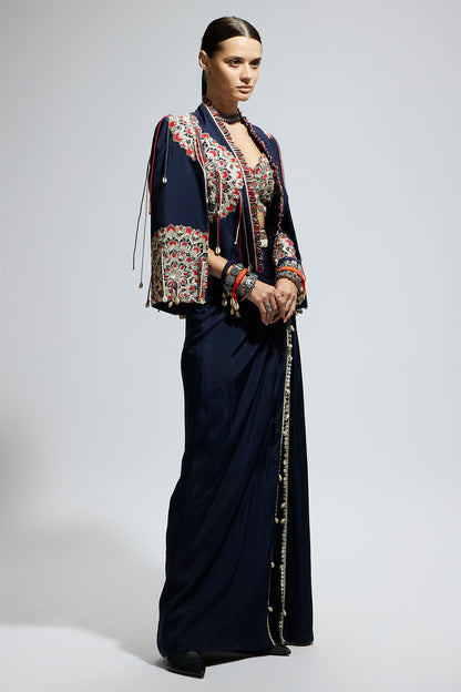 Blue Asymetric Threadwork Cape Jacket Paired with An Embellished Bustier and High Slit Skirt