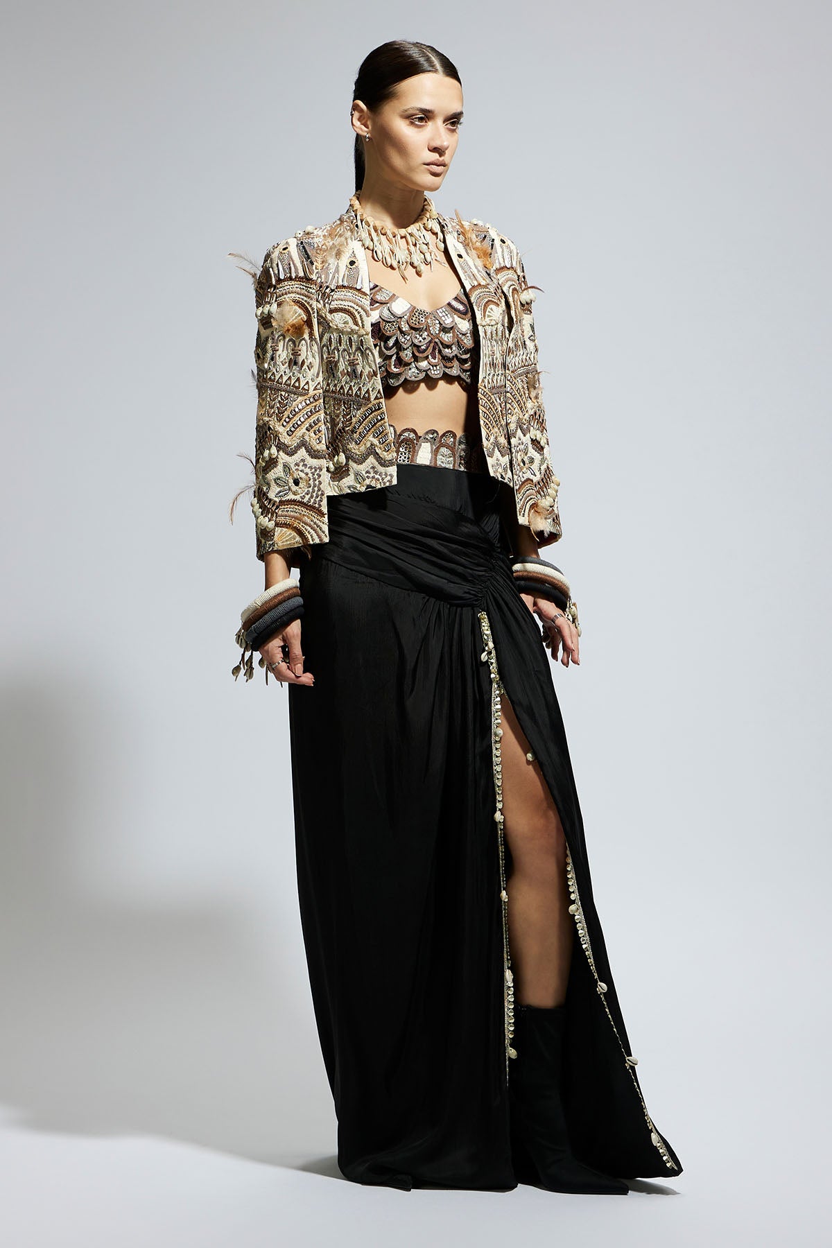 Ivory Abstract Feather Cape Jacket Paired with 3 D Scallop Bustier and Black High Slit Skirt