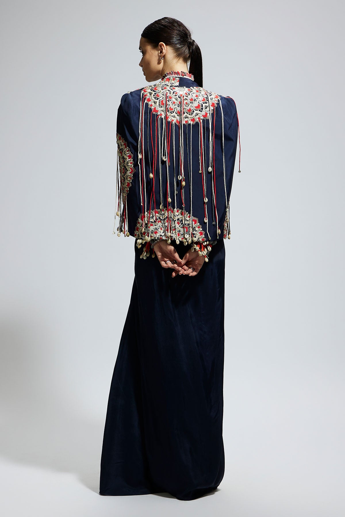 Blue Asymetric Threadwork Cape Jacket Paired with An Embellished Bustier and High Slit Skirt