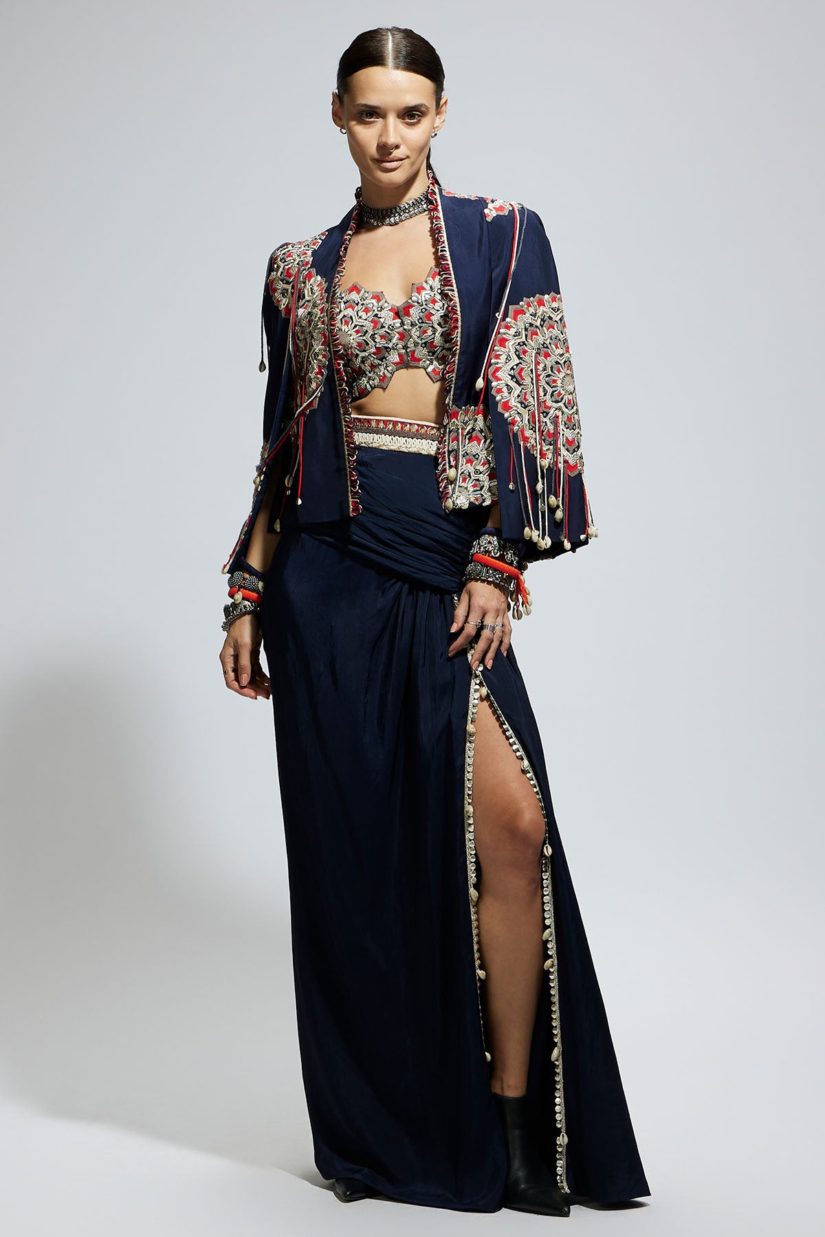 Blue Asymetric Threadwork Cape Jacket Paired with An Embellished Bustier and High Slit Skirt