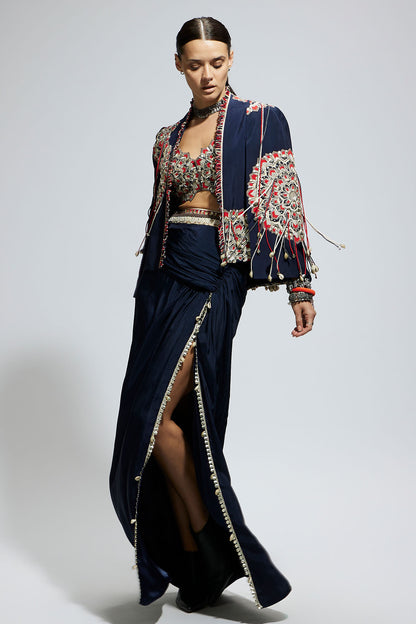 Blue Asymetric Threadwork Cape Jacket Paired with An Embellished Bustier and High Slit Skirt