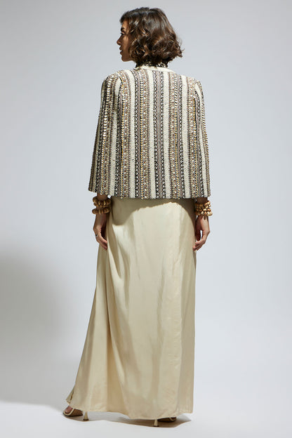 Embellished & Textured Cape Jacket Paired with Metallic Scallop Bustier and Ivory  High Slit Skirt