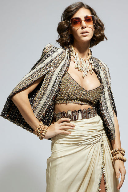 Embellished & Textured Cape Jacket Paired with Metallic Scallop Bustier and Ivory  High Slit Skirt